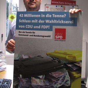 Guido van den Berg mit Plakat gegen Steuerverschwendung