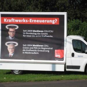 Plakat zur scheinheiligen Politik der Kraftwerkserneuerung von CDU/CSU